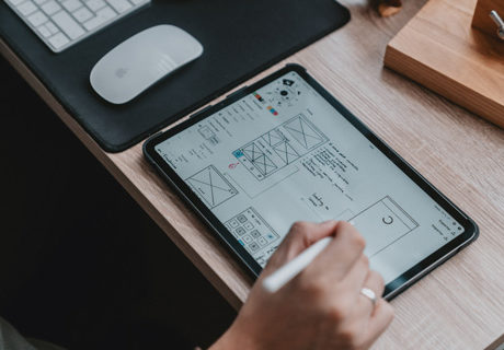person designing website on iPad